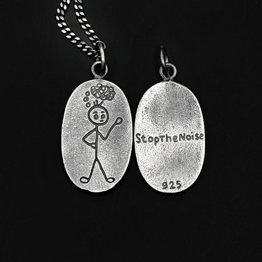 Silver pendant with a stick figure design and 'StopTheNoise' engraving on a black background