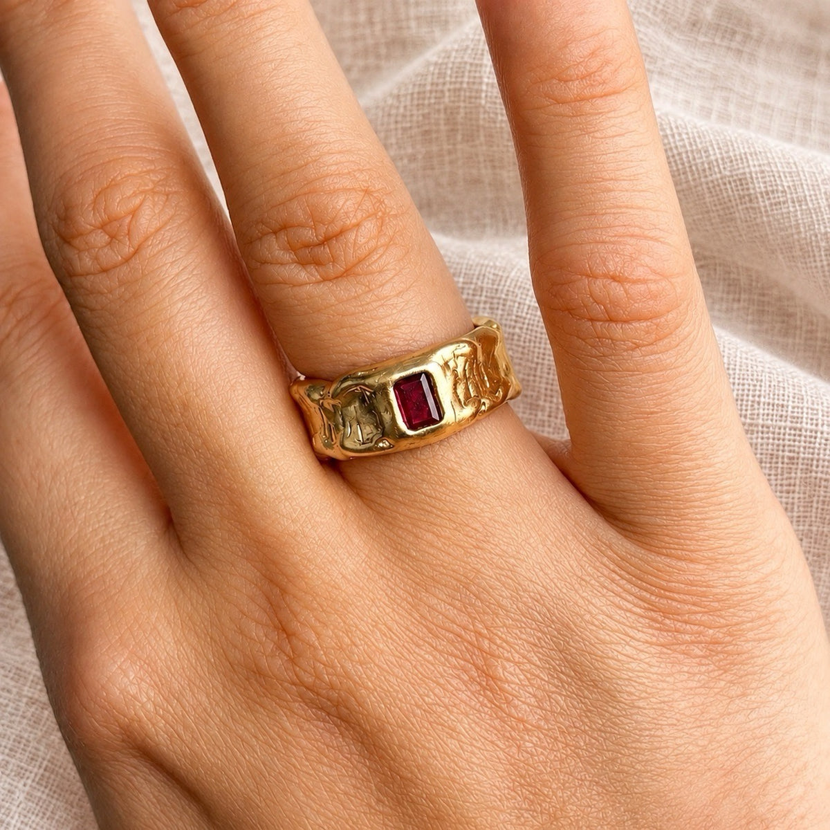 rectangular molten ring with red birthstone