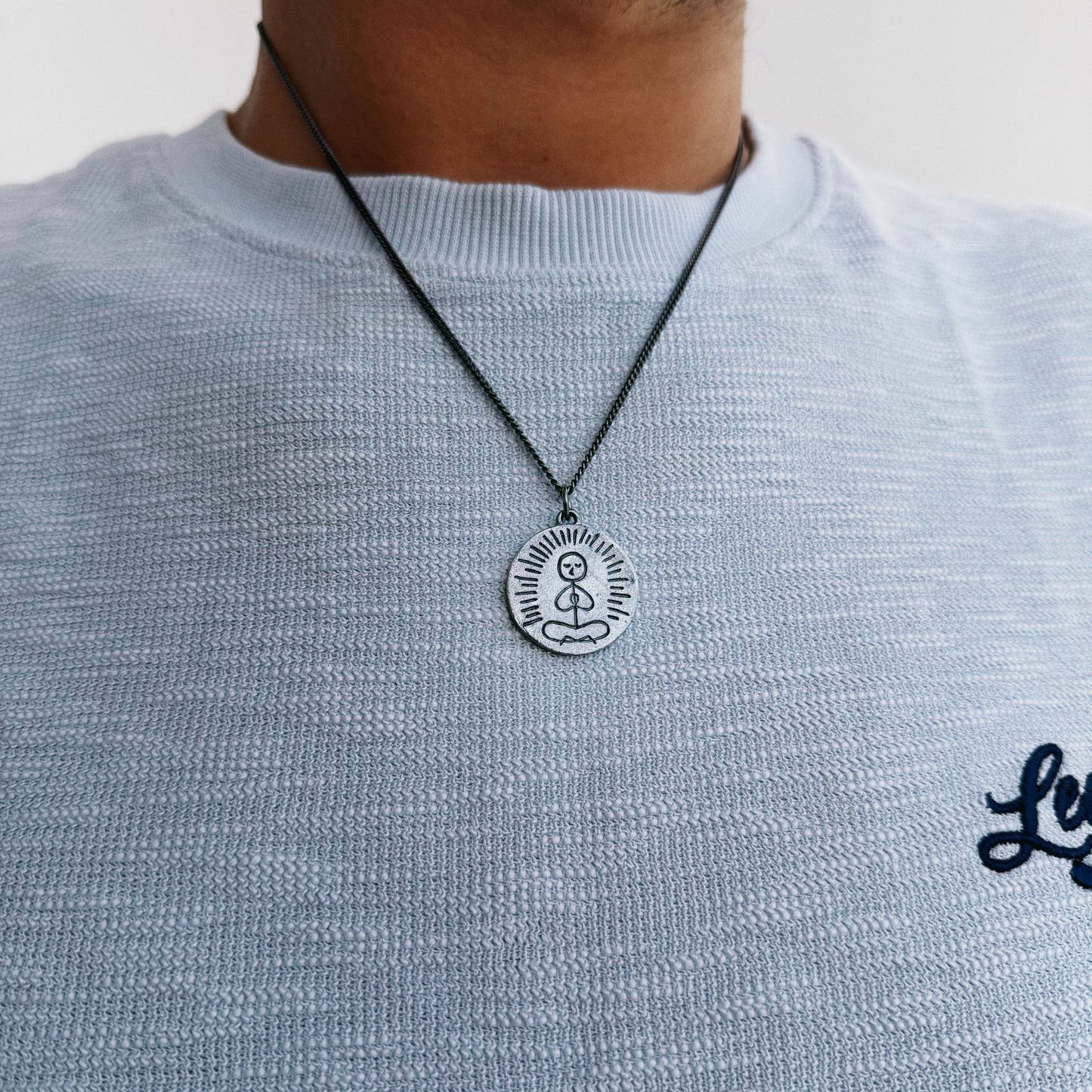 Necklace worn on model for scale front