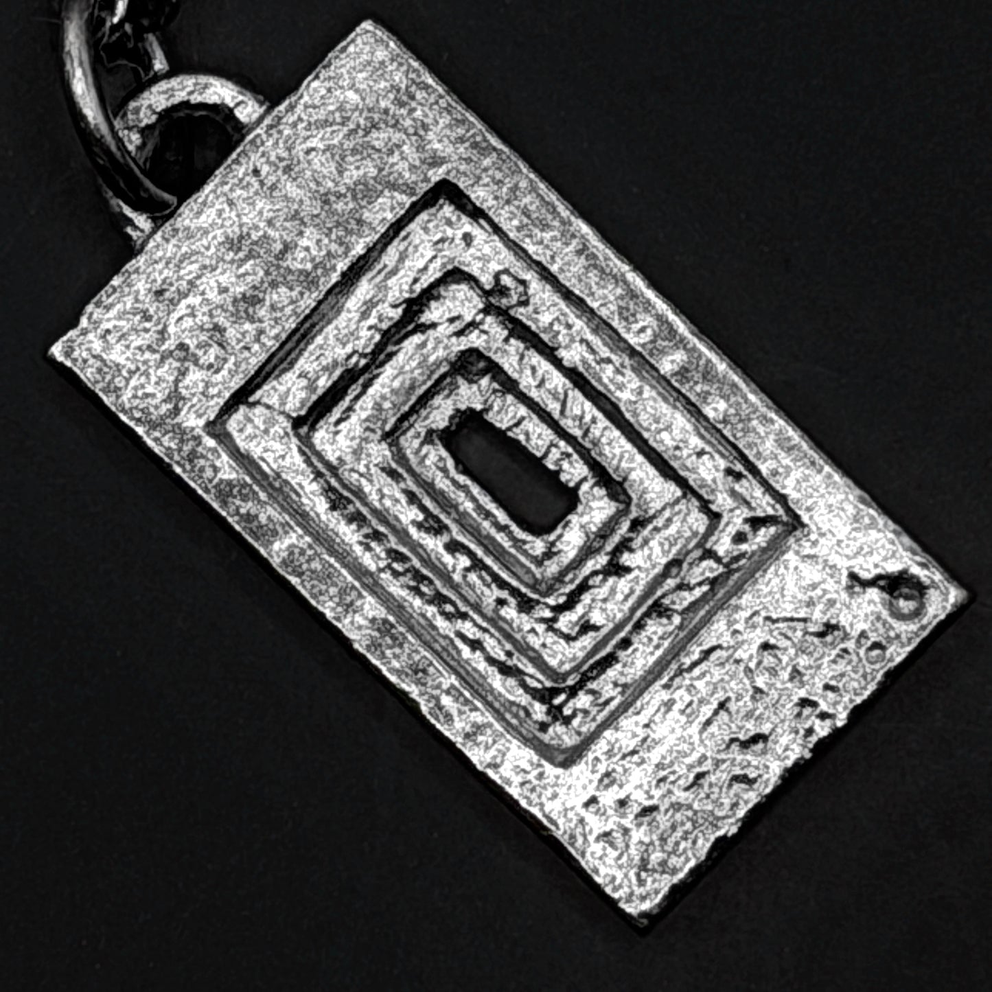 Close-up detail of silver pendant texture 