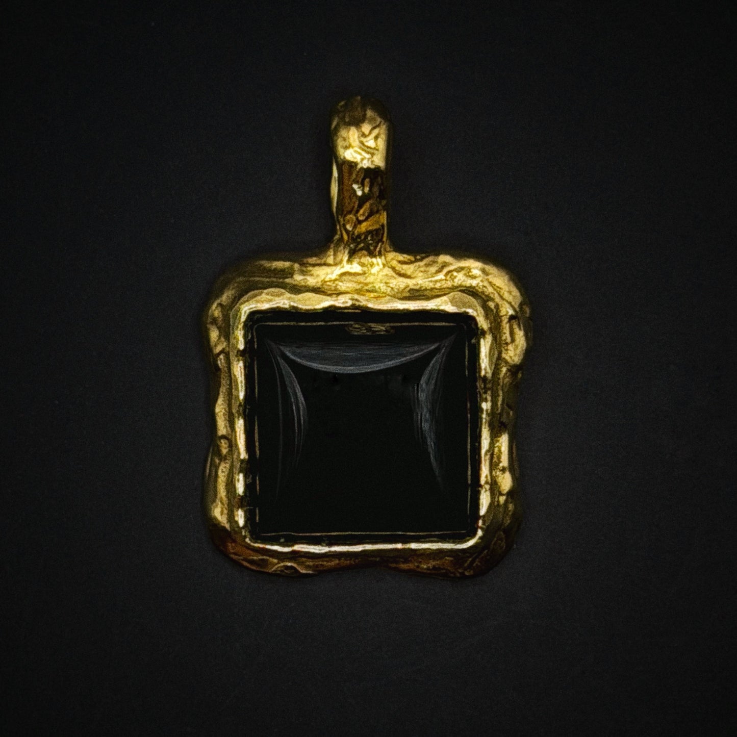 Close-up detail of gold pendant texture
