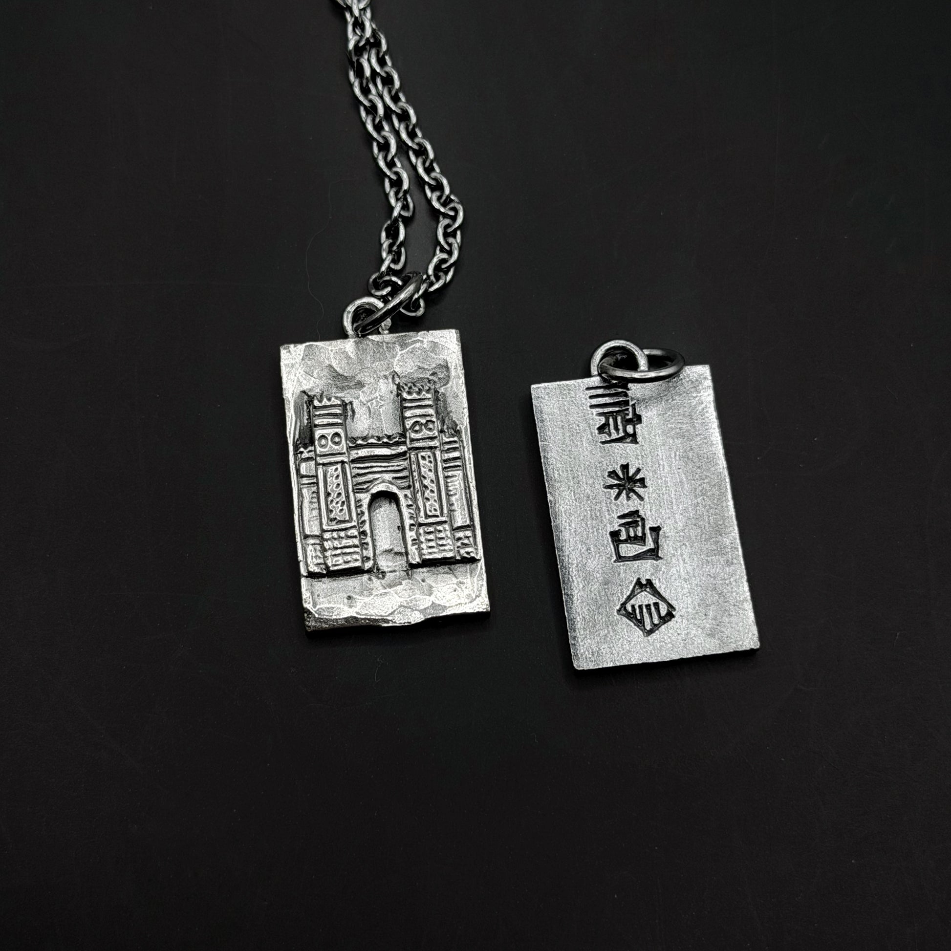  silver pendant on a black background