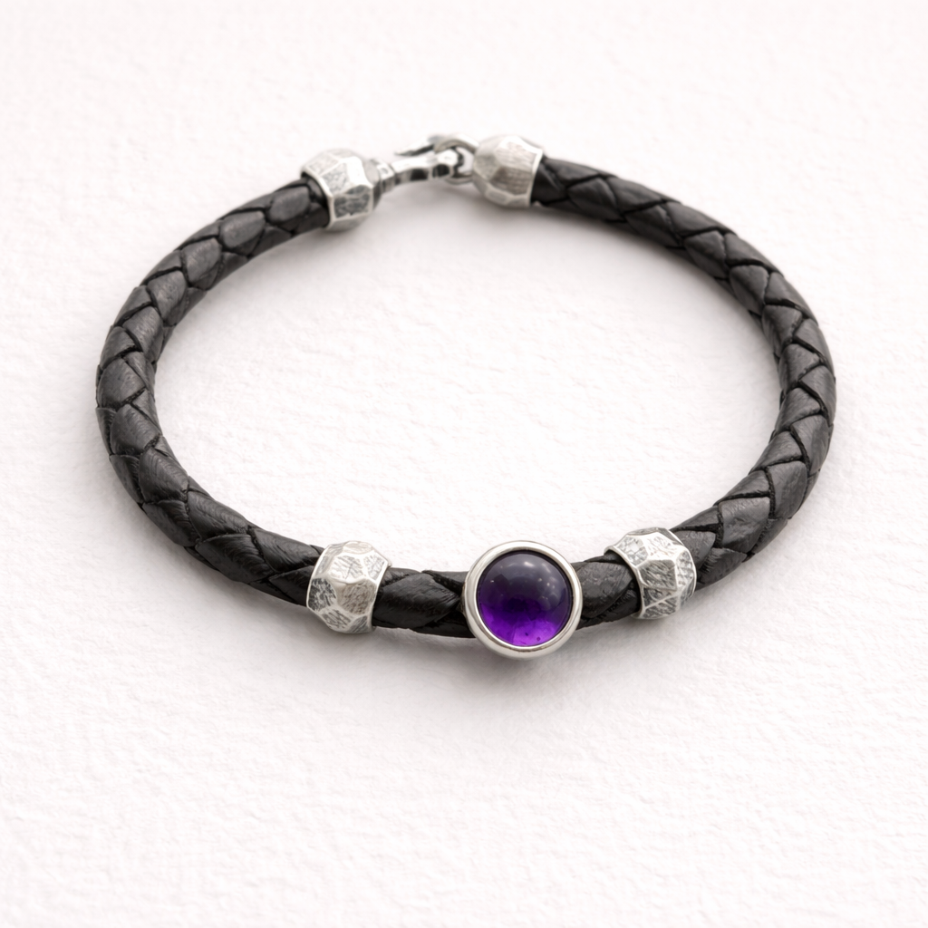 Black braided leather bracelet with a purple gemstone and silver accents on a white background