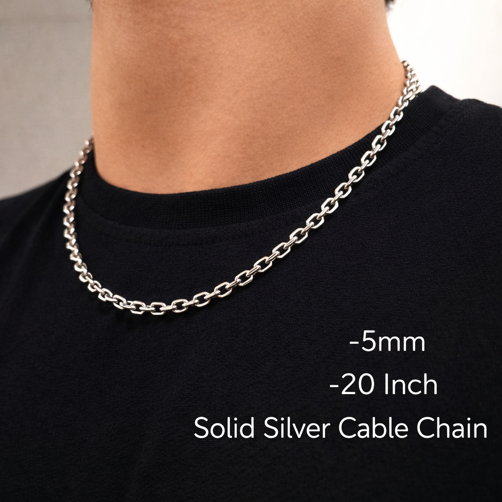 Solid silver cable chain necklace on a person wearing a black shirt.