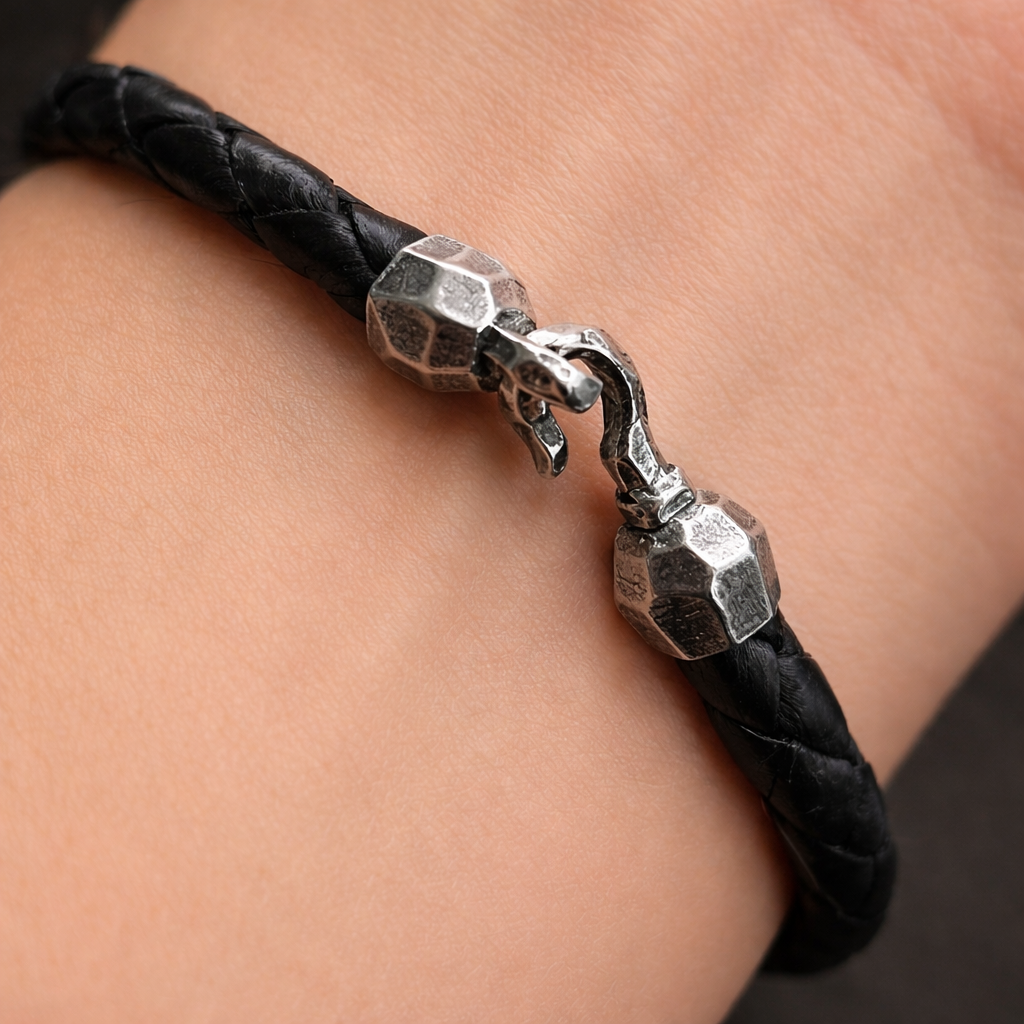 Black leather bracelet with silver clasp on a wrist