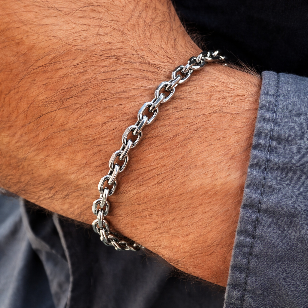 Close-up of a silver chain bracelet on a person's wrist.